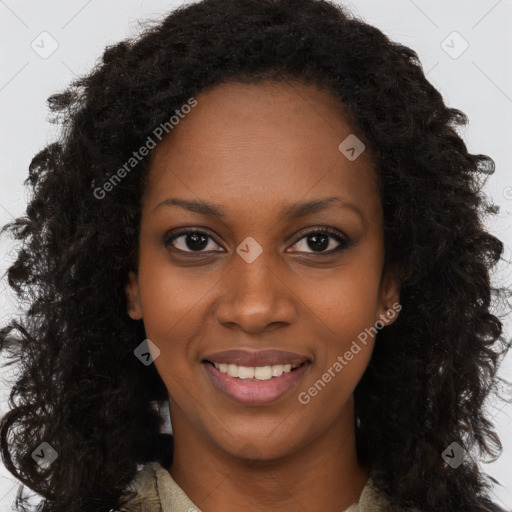 Joyful black young-adult female with long  brown hair and brown eyes