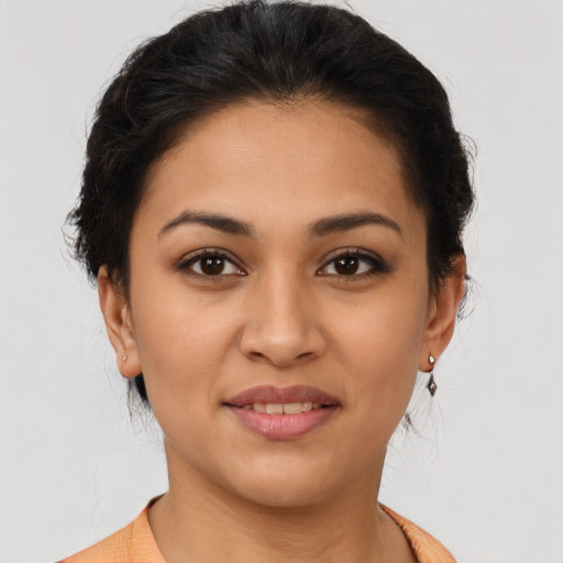 Joyful latino young-adult female with medium  brown hair and brown eyes