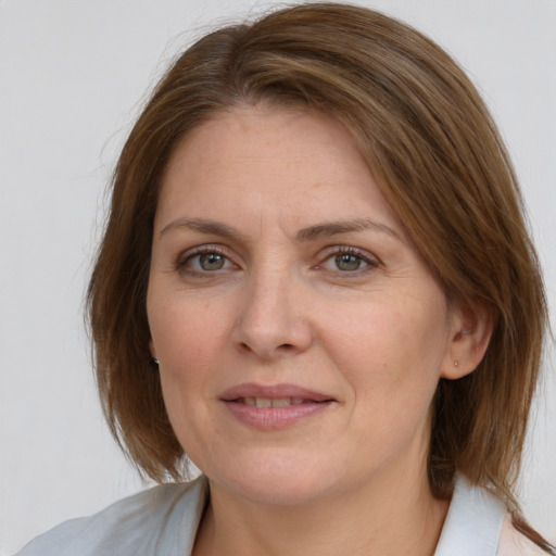 Joyful white adult female with medium  brown hair and grey eyes