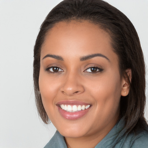 Joyful latino young-adult female with long  brown hair and brown eyes