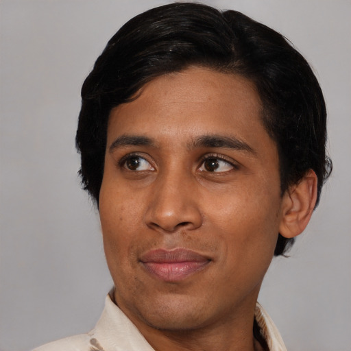 Joyful latino young-adult male with short  black hair and brown eyes