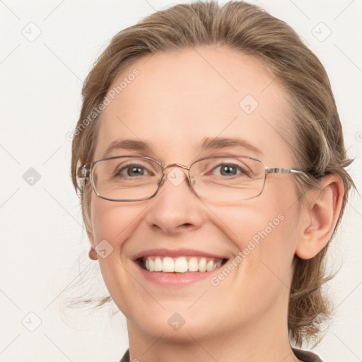 Joyful white adult female with medium  brown hair and blue eyes