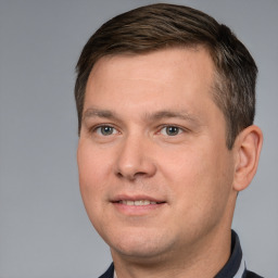 Joyful white adult male with short  brown hair and brown eyes