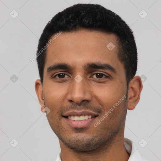 Joyful latino young-adult male with short  black hair and brown eyes