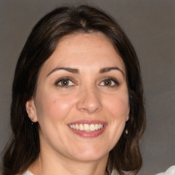 Joyful white adult female with medium  brown hair and brown eyes