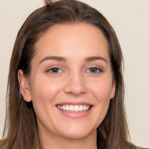 Joyful white young-adult female with long  brown hair and brown eyes