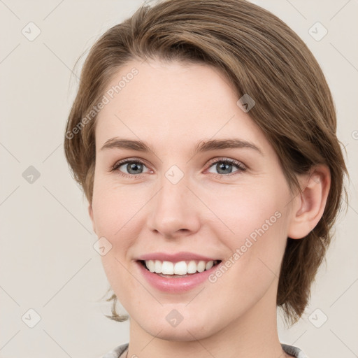 Joyful white young-adult female with medium  brown hair and green eyes