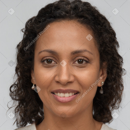 Joyful black young-adult female with long  brown hair and brown eyes