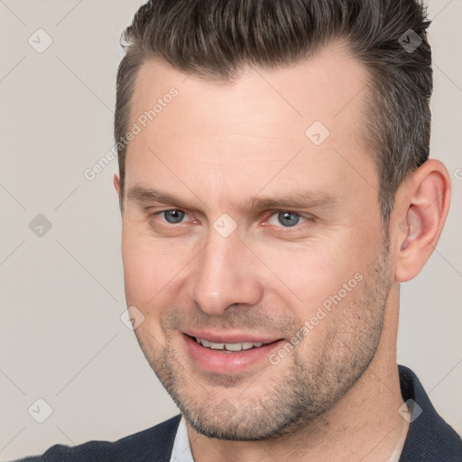 Joyful white adult male with short  brown hair and brown eyes