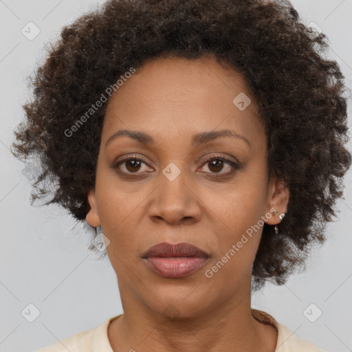 Joyful black adult female with short  brown hair and brown eyes