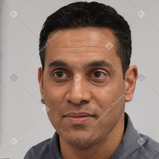 Joyful white adult male with short  black hair and brown eyes