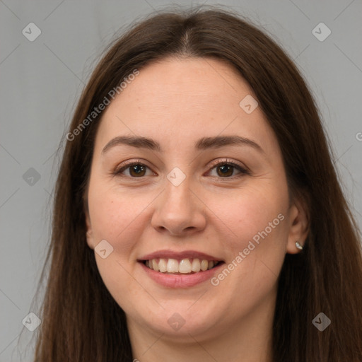 Joyful white young-adult female with long  brown hair and brown eyes