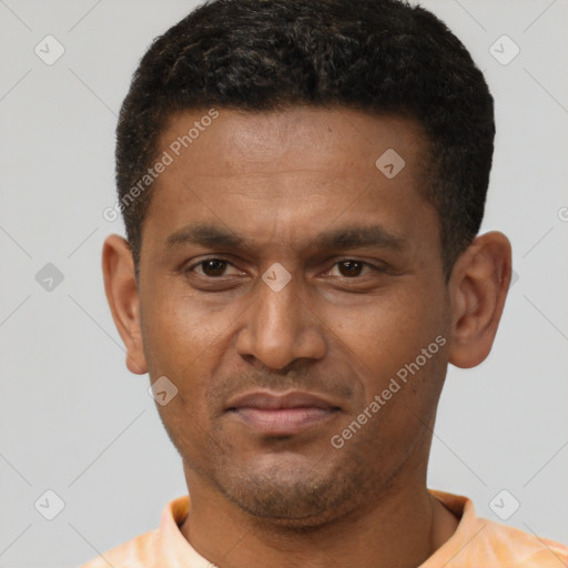 Joyful latino young-adult male with short  brown hair and brown eyes
