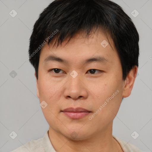 Joyful asian young-adult male with short  brown hair and brown eyes