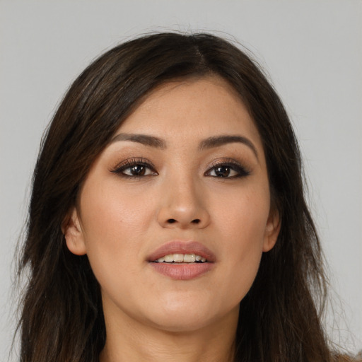 Joyful asian young-adult female with long  brown hair and brown eyes