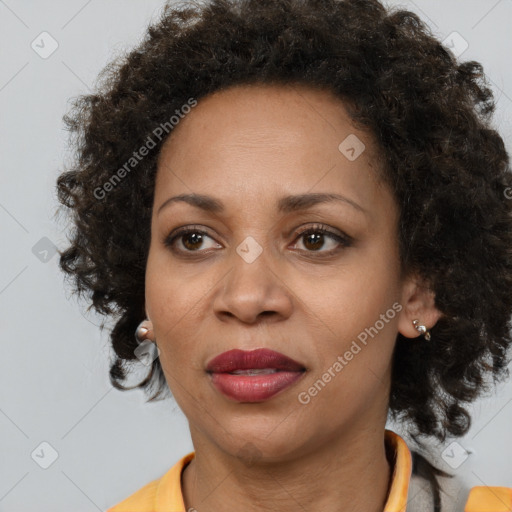 Joyful black adult female with medium  brown hair and brown eyes