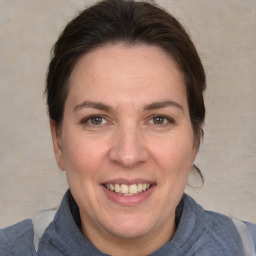 Joyful white adult female with medium  brown hair and grey eyes