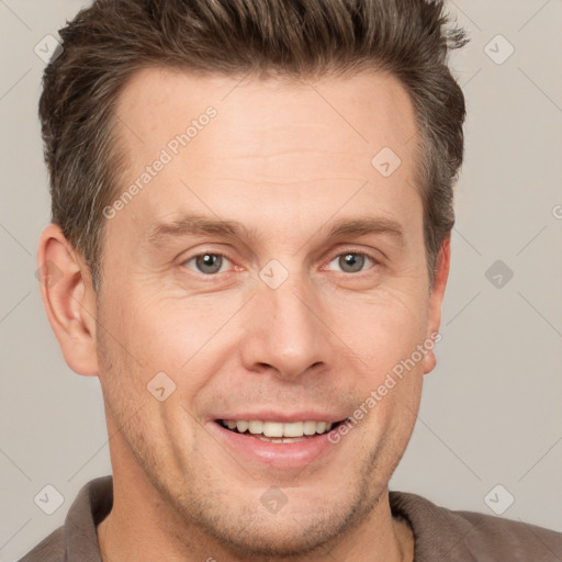 Joyful white adult male with short  brown hair and grey eyes