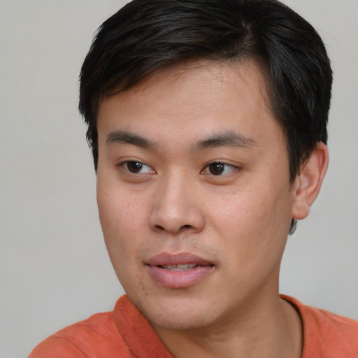 Joyful asian young-adult male with short  brown hair and brown eyes