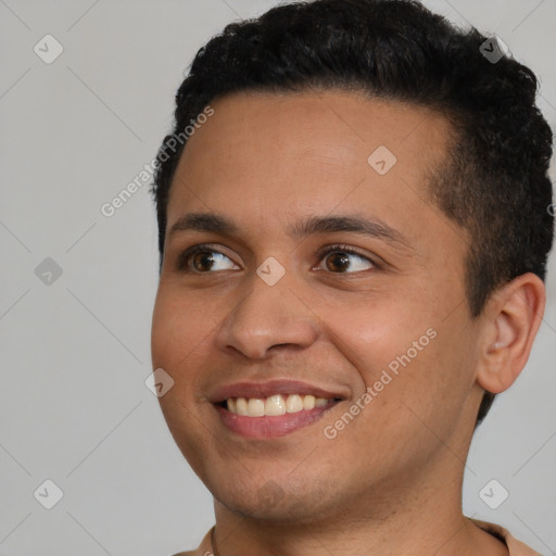 Joyful black young-adult male with short  black hair and brown eyes