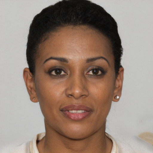 Joyful black young-adult female with short  brown hair and brown eyes