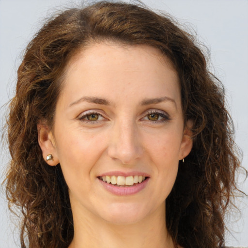 Joyful white young-adult female with long  brown hair and green eyes