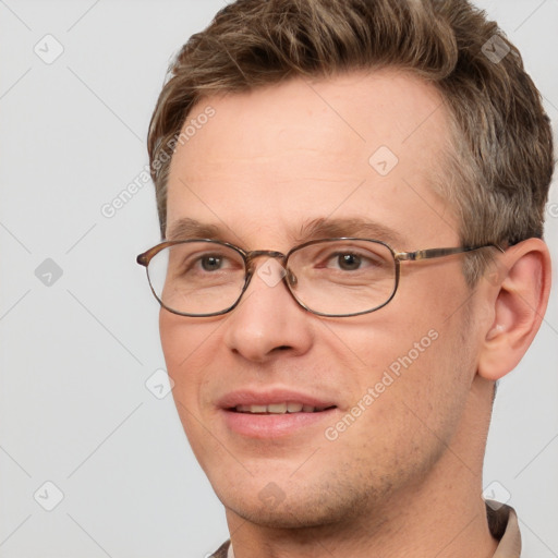 Joyful white adult male with short  brown hair and grey eyes