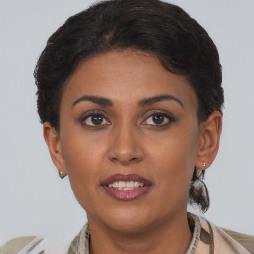 Joyful black young-adult female with short  brown hair and brown eyes