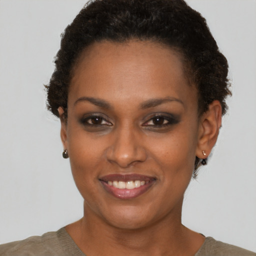 Joyful black young-adult female with short  brown hair and brown eyes