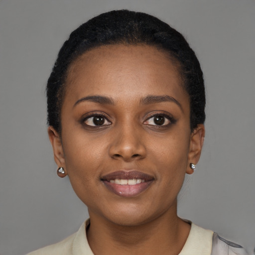 Joyful black young-adult female with short  brown hair and brown eyes