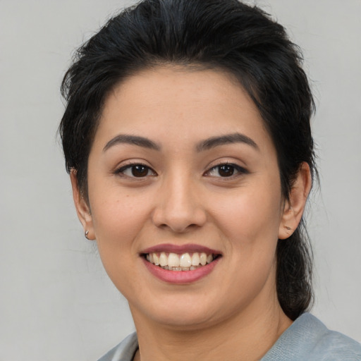 Joyful asian young-adult female with medium  brown hair and brown eyes