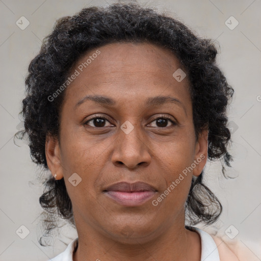 Joyful black adult female with short  brown hair and brown eyes