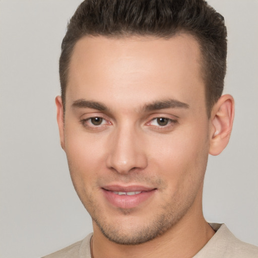 Joyful white young-adult male with short  brown hair and brown eyes