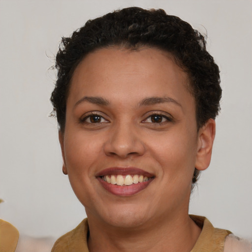 Joyful latino young-adult female with short  brown hair and brown eyes