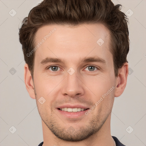 Joyful white young-adult male with short  brown hair and grey eyes