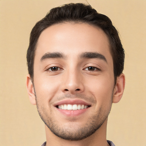 Joyful white young-adult male with short  black hair and brown eyes