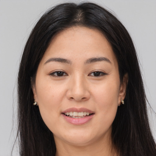 Joyful asian young-adult female with long  brown hair and brown eyes