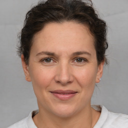 Joyful white adult female with short  brown hair and brown eyes