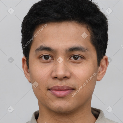 Joyful latino young-adult male with short  brown hair and brown eyes