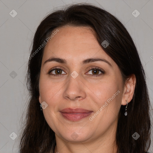 Joyful white adult female with long  brown hair and brown eyes