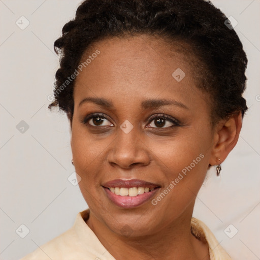 Joyful black young-adult female with short  brown hair and brown eyes