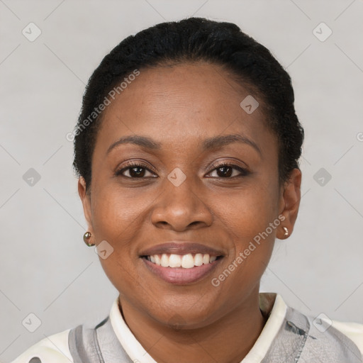 Joyful black young-adult female with short  black hair and brown eyes