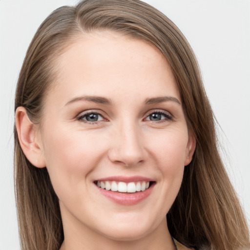 Joyful white young-adult female with long  brown hair and grey eyes