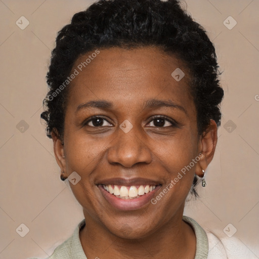 Joyful black adult female with short  black hair and brown eyes