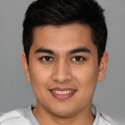 Joyful latino young-adult male with short  brown hair and brown eyes