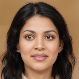 Joyful latino young-adult female with long  brown hair and brown eyes