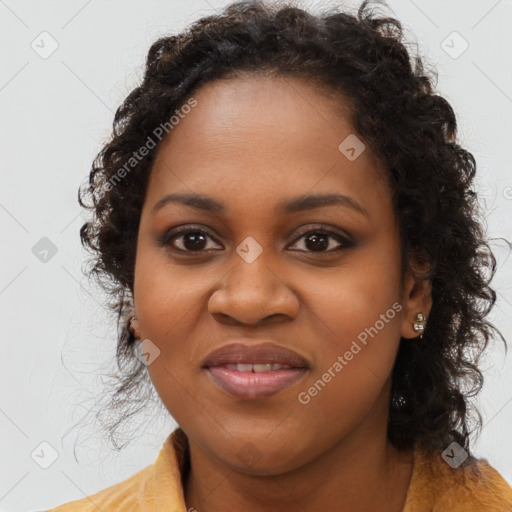 Joyful black young-adult female with long  brown hair and brown eyes