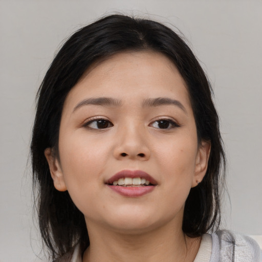 Joyful asian young-adult female with medium  brown hair and brown eyes