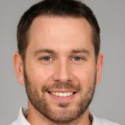 Joyful white adult male with short  brown hair and brown eyes