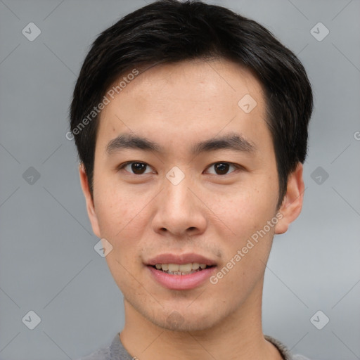 Joyful asian young-adult male with short  black hair and brown eyes